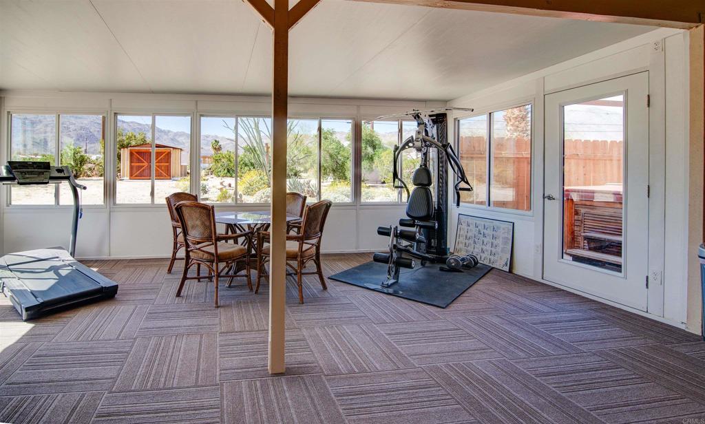 3456 El Tejon Road Borrego Springs, CA 92004 - Photo 13 of 17 a view of a dining room with furniture large windows and wooden floor