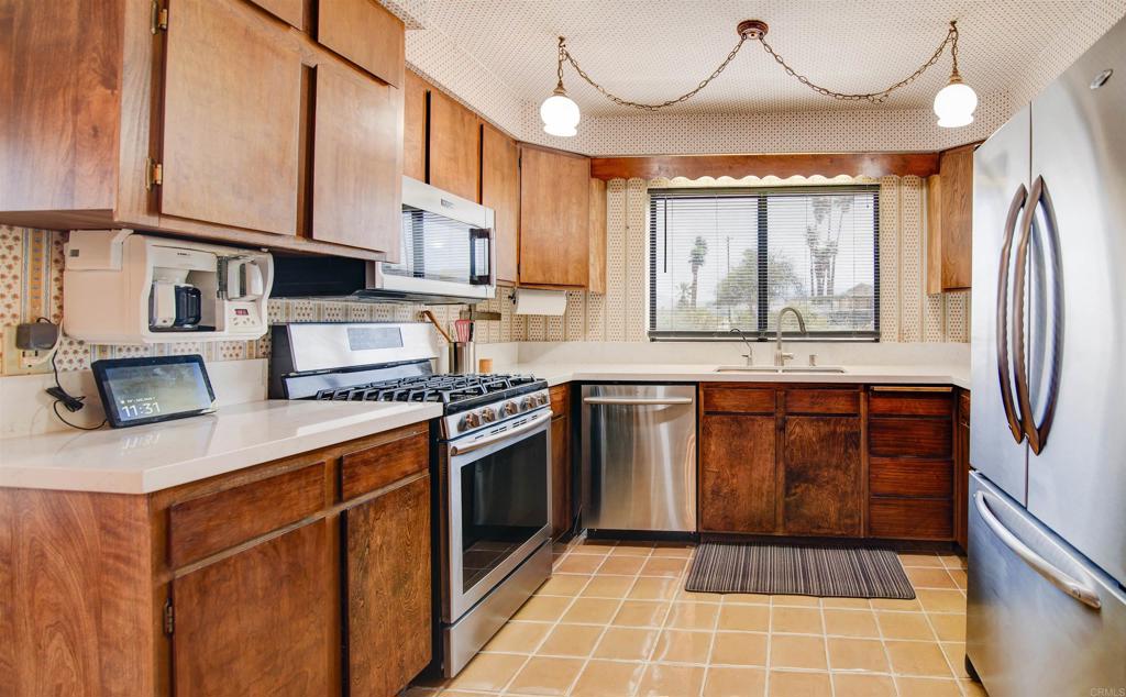 3456 El Tejon Road Borrego Springs, CA 92004 - Photo 2 of 17 a kitchen with stainless steel appliances granite countertop a stove a sink and a refrigerator