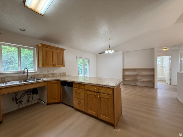 838 East Mountain Road Logan, UT 84321 - Photo 10 of 37 Kitchen featuring a central island with tiled countertop, wood cabinetry, dual basin stainless steel sink, and a stainless steel dishwasher