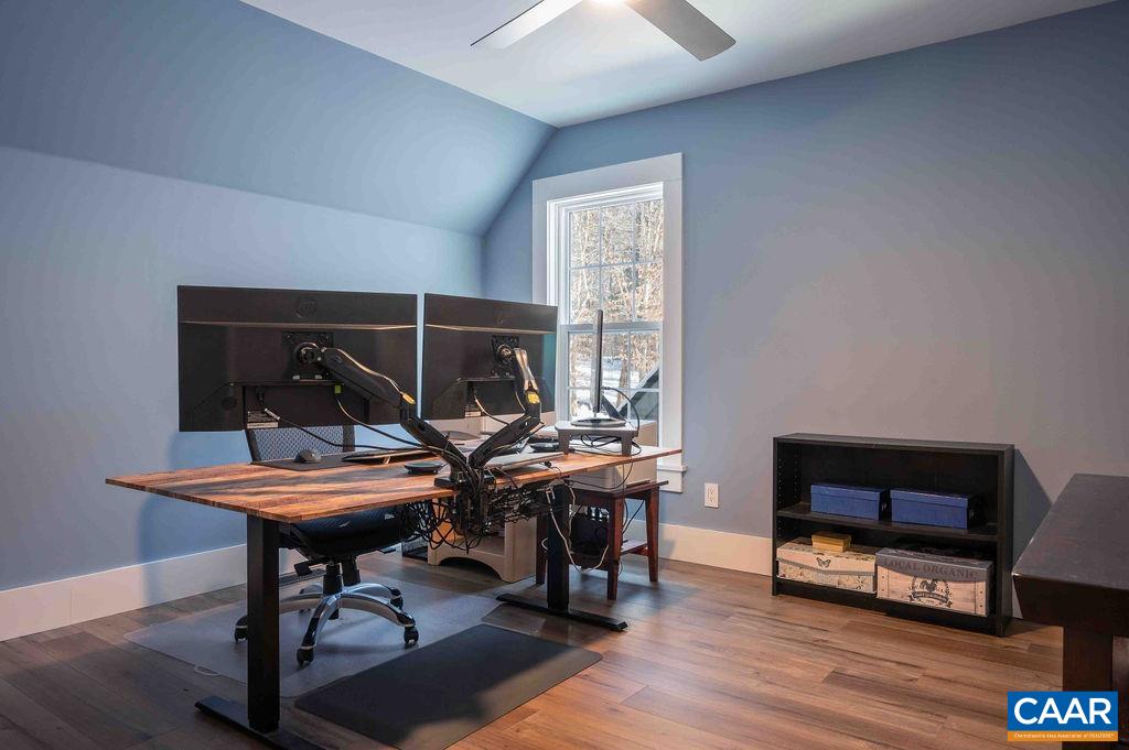 1205 Hunters Ridge Road Earlysville, VA 22936 - Photo 19 of 35 a view of a workspace with furniture and a window