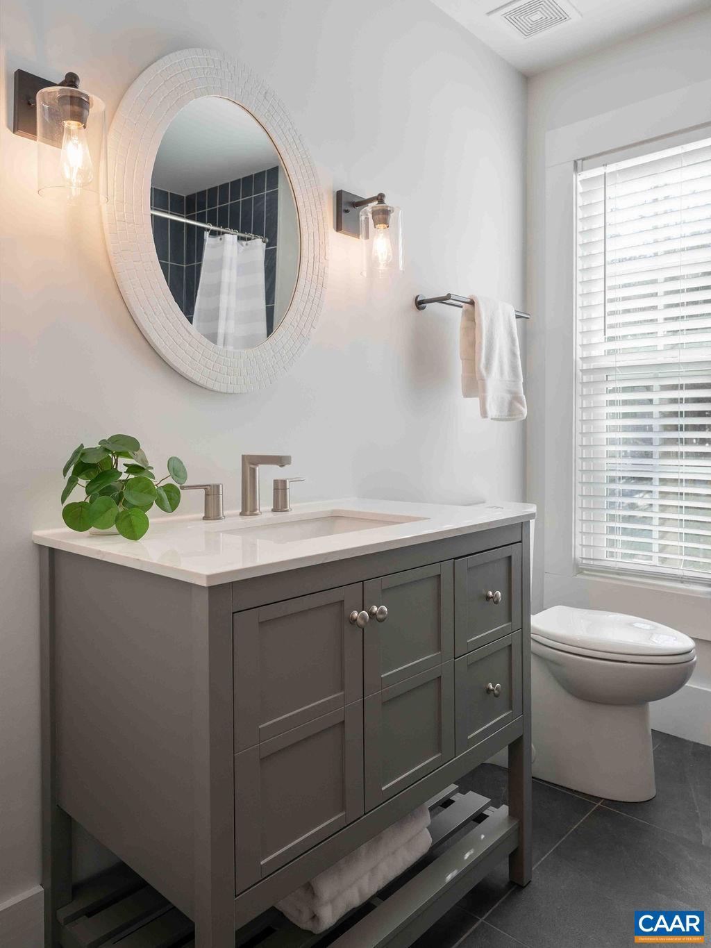 1205 Hunters Ridge Road Earlysville, VA 22936 - Photo 23 of 35 a bathroom with a toilet a sink and mirror