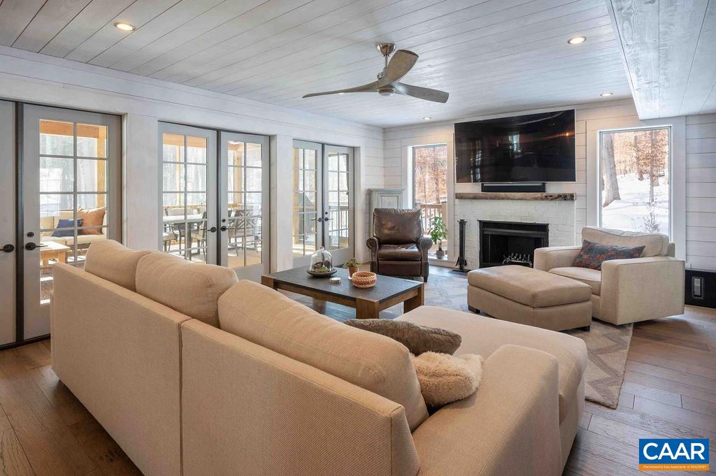 1205 Hunters Ridge Road Earlysville, VA 22936 - Photo 7 of 35 a living room with furniture flat screen tv and a fireplace