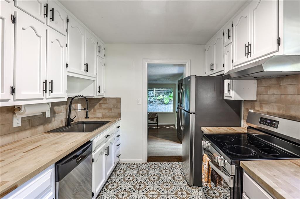 878 Scott Circle Decatur, GA 30033 - Photo 15 of 30 a kitchen with granite countertop a sink stove and cabinets