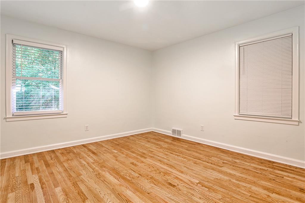 878 Scott Circle Decatur, GA 30033 - Photo 9 of 30 a view of an empty room with wooden floor and a window
