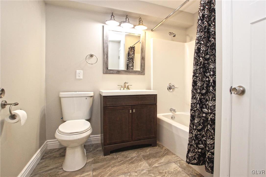 565 Long Mountain Road Effort, PA 18330 - Photo 28 of 34 a bathroom with a sink a toilet and shower curtain