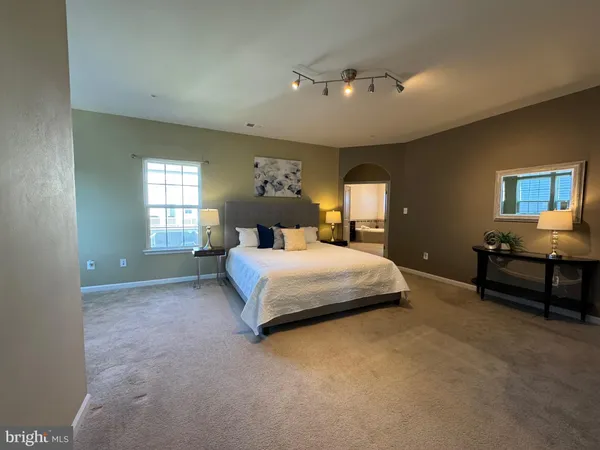 a spacious bedroom with a bed and window