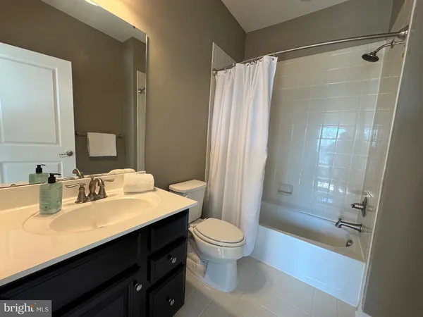 a spacious bedroom with a bed and a window
