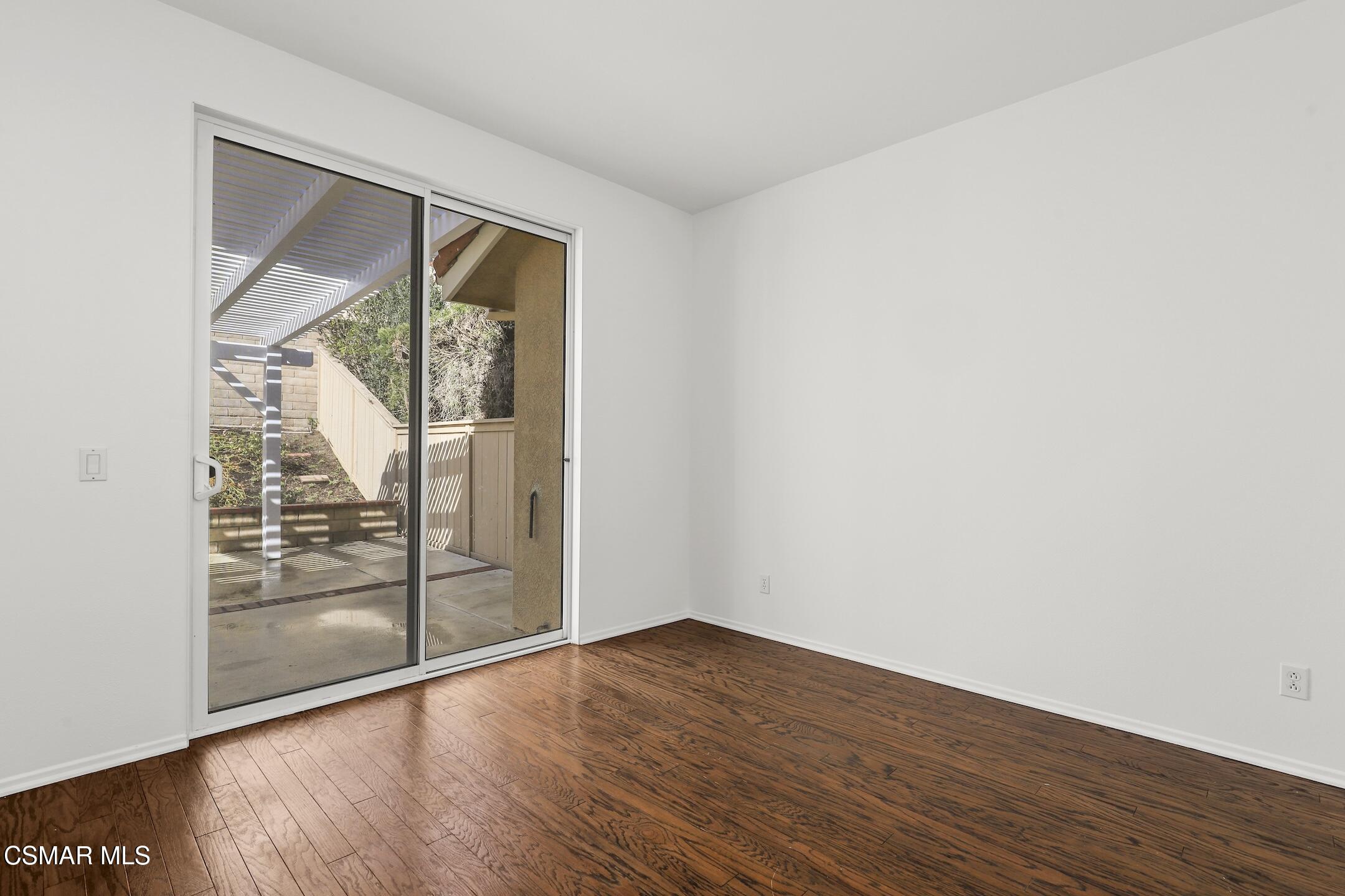 495 Novara Way Oak Park, CA 91377 - Photo 11 of 26 a view of an empty room with wooden floor and a window
