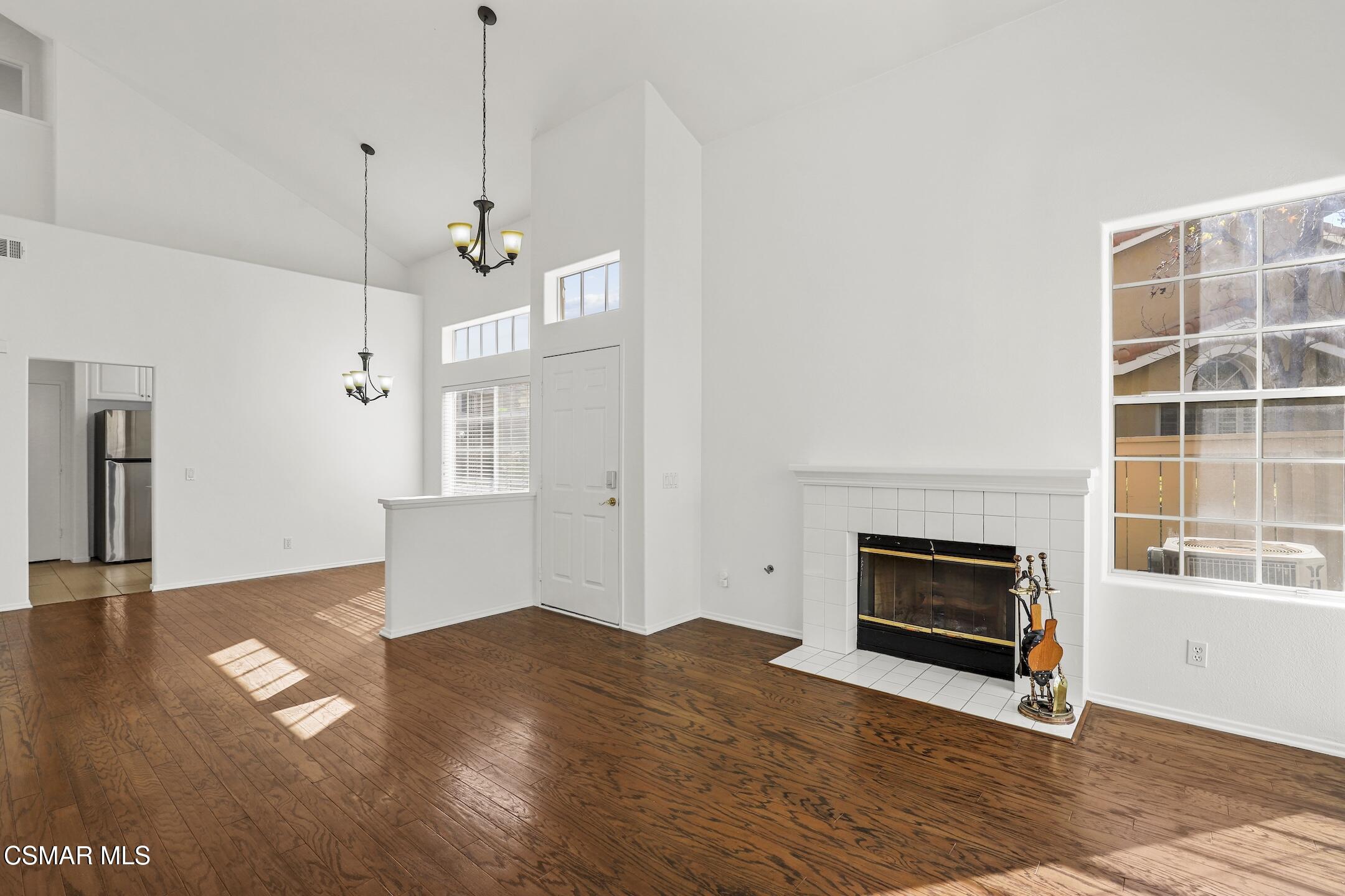495 Novara Way Oak Park, CA 91377 - Photo 5 of 26 a view of empty room with wooden floor and fireplace