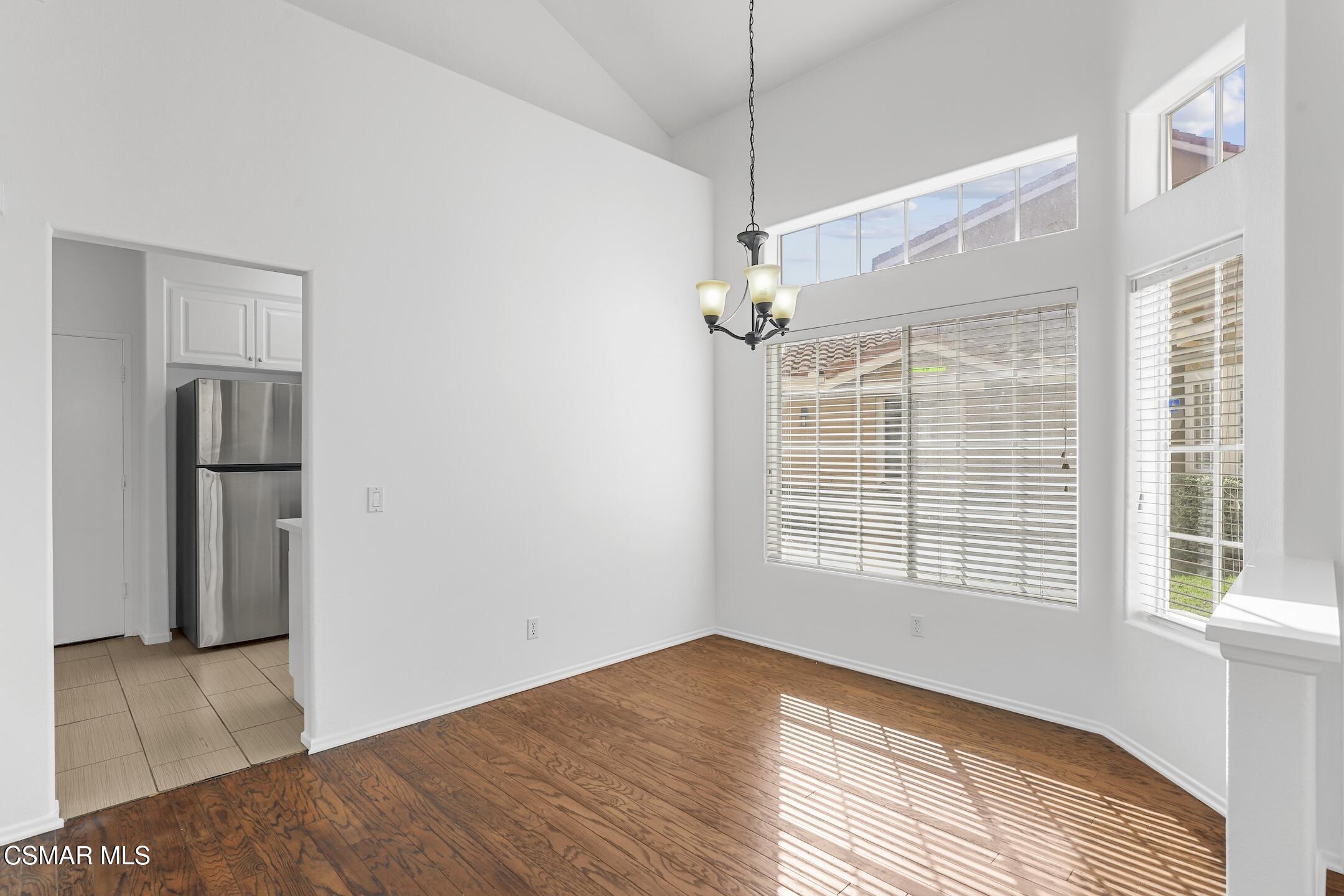 495 Novara Way Oak Park, CA 91377 - Photo 6 of 26 a view of an empty room with a window and wooden floor