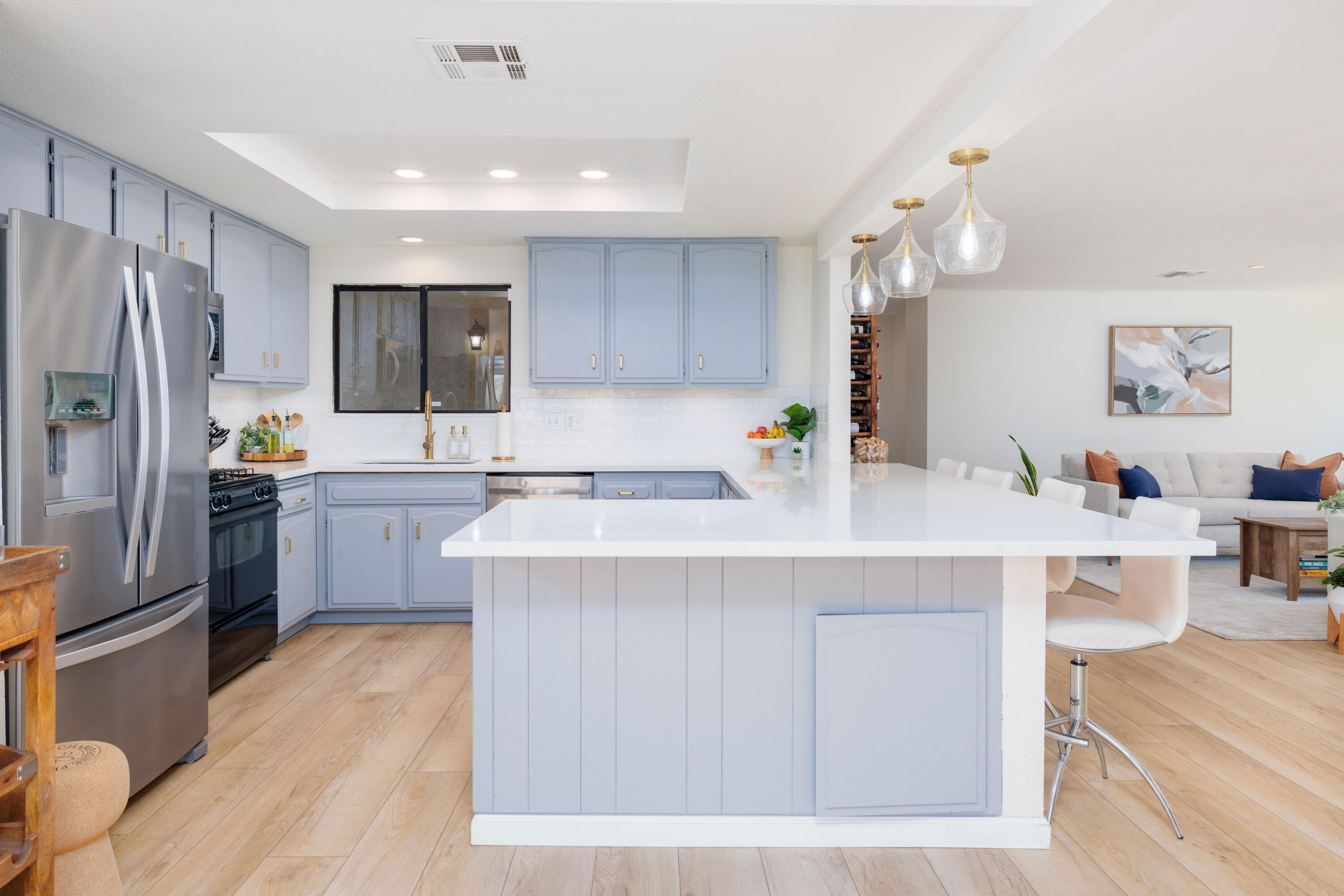 67395 Rango Road Cathedral City, CA 92234 - Photo 11 of 36 a kitchen with stainless steel appliances a sink a stove a refrigerator cabinets and a dining table