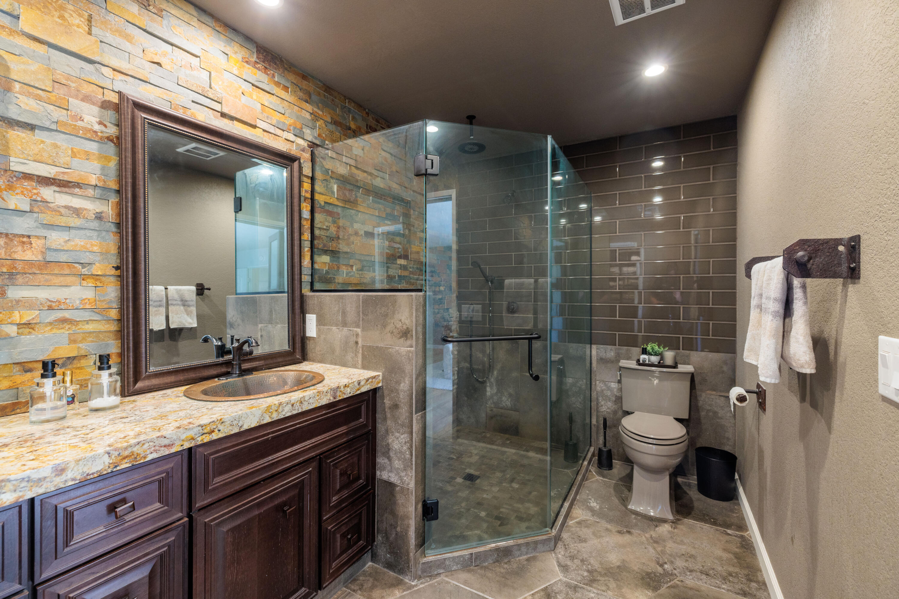 67395 Rango Road Cathedral City, CA 92234 - Photo 16 of 36 a bathroom with a granite countertop sink a toilet a mirror and shower