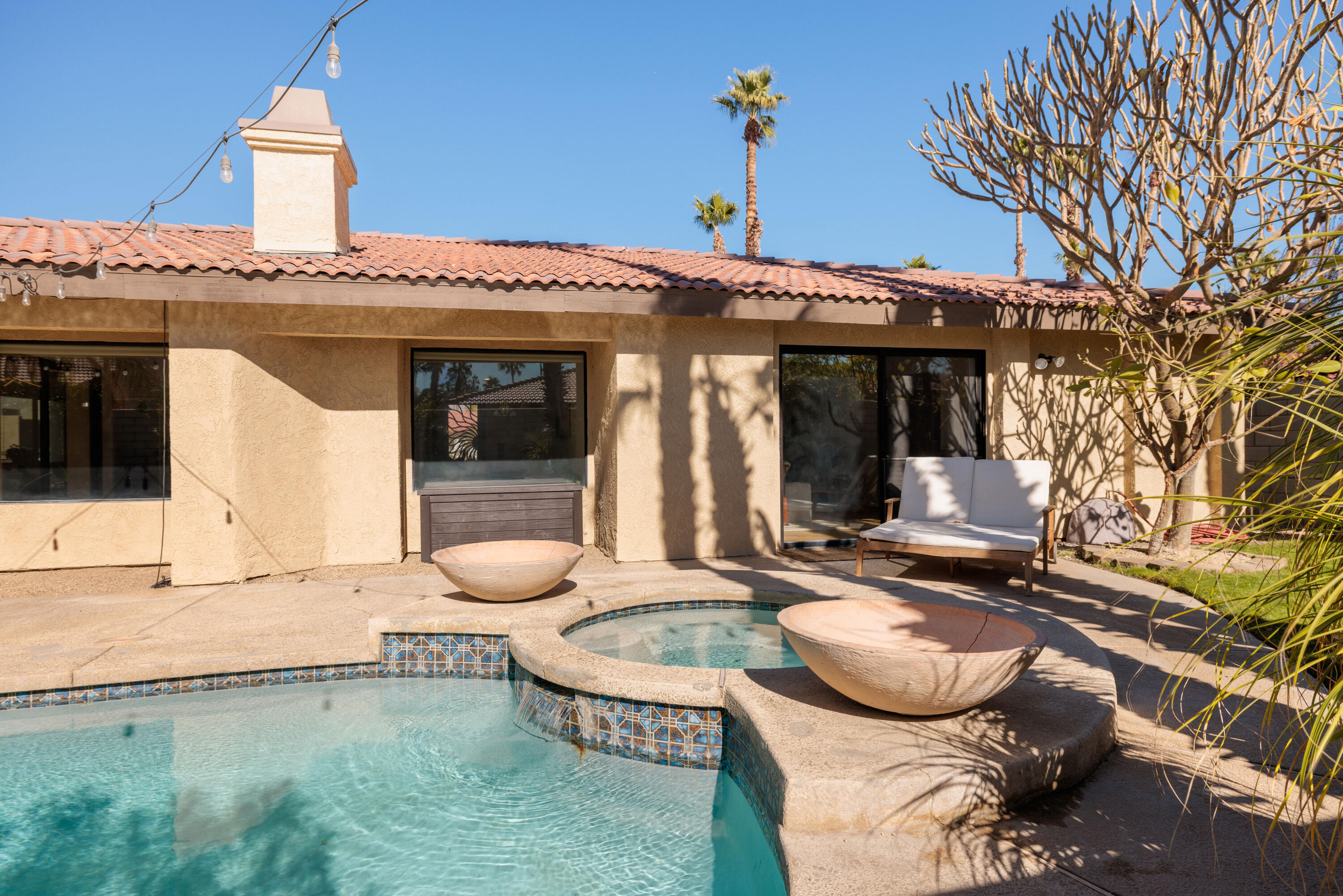67395 Rango Road Cathedral City, CA 92234 - Photo 29 of 36 a front view of a house with patio furniture and a fire pit
