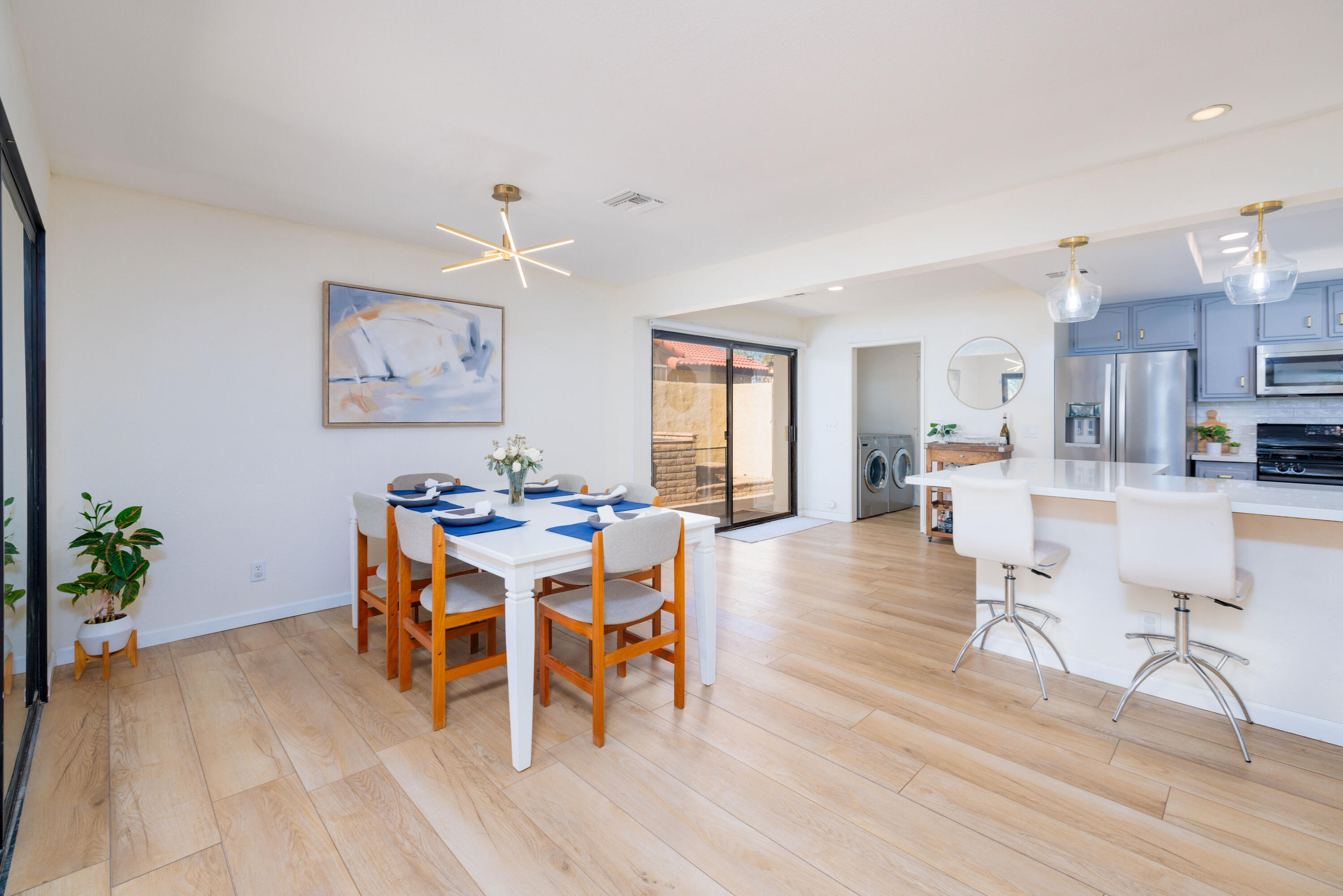 67395 Rango Road Cathedral City, CA 92234 - Photo 9 of 36 a view of a dining room with furniture and wooden floor