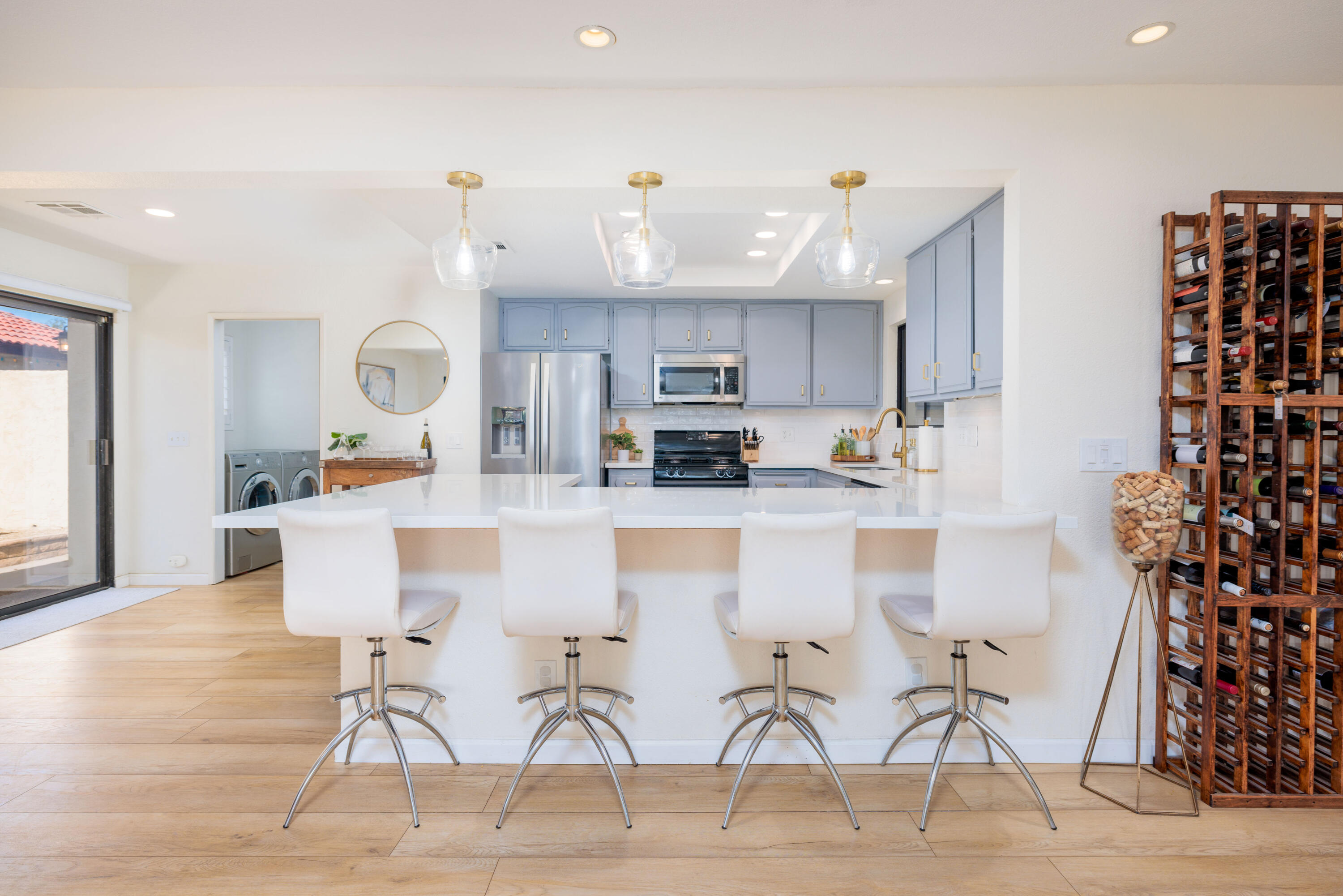 67395 Rango Road Cathedral City, CA 92234 - Photo 10 of 36 a kitchen with stainless steel appliances kitchen island granite countertop a table and chairs in it