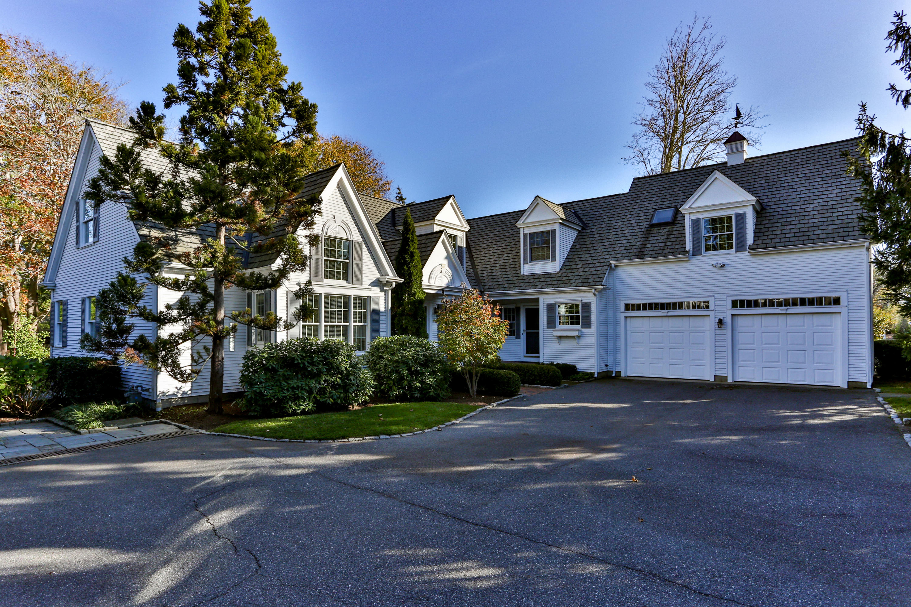 38 Parker Road Osterville, MA 02655 - Photo 1 of 58 a front view of a house with a yard and garage