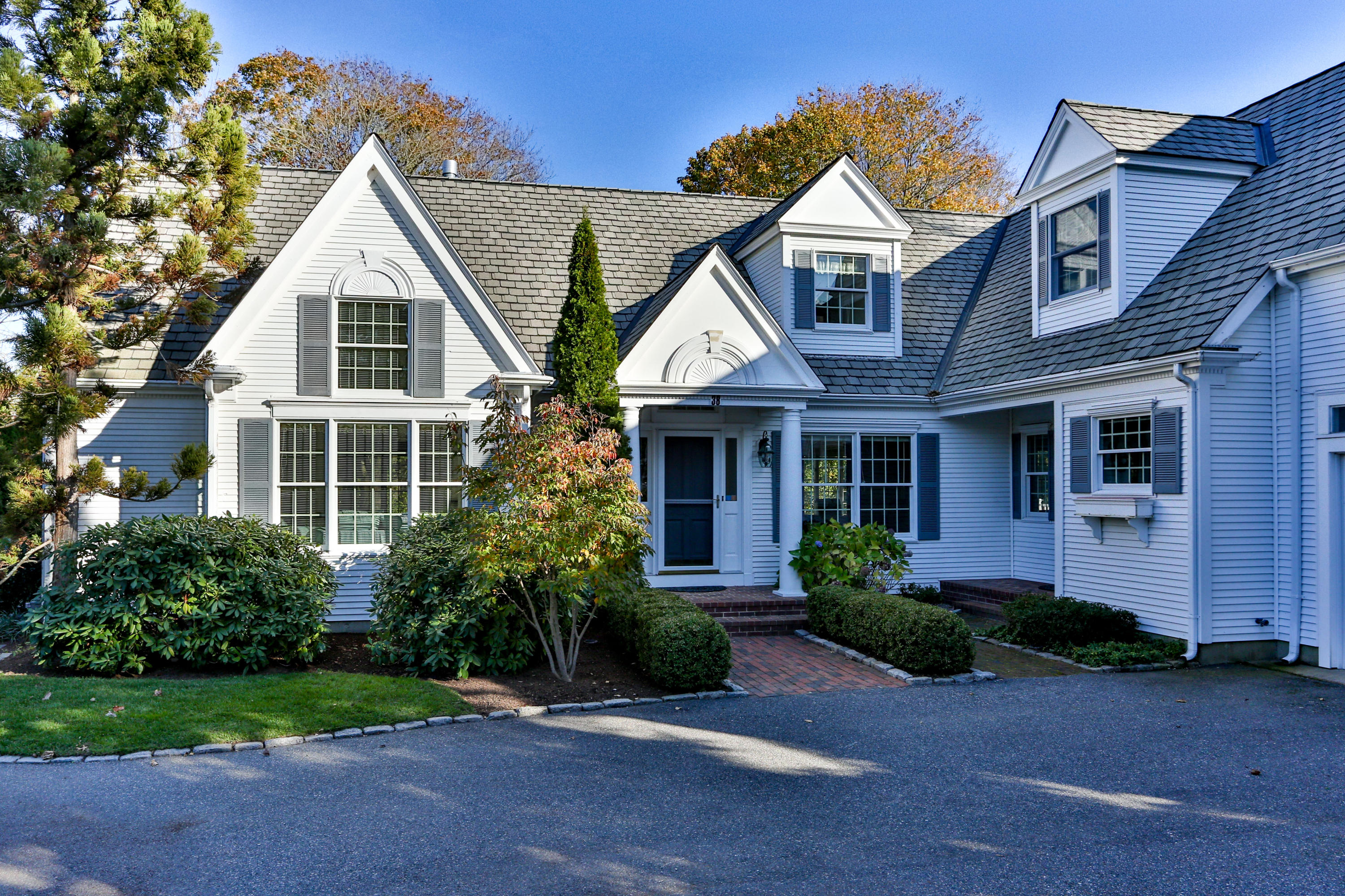 38 Parker Road Osterville, MA 02655 - Photo 2 of 58 a front view of a house with a yard and trees