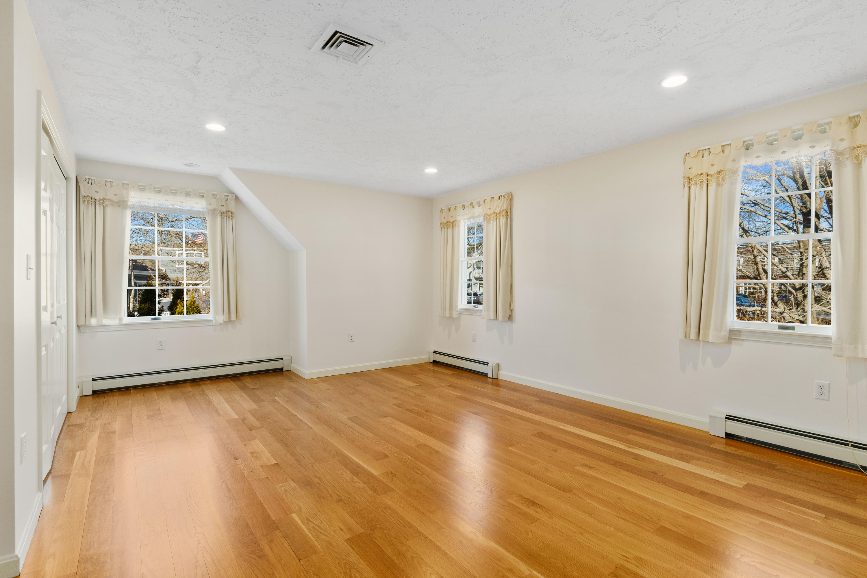 38 Parker Road Osterville, MA 02655 - Photo 26 of 58 a view of an empty room with a window and wooden floor