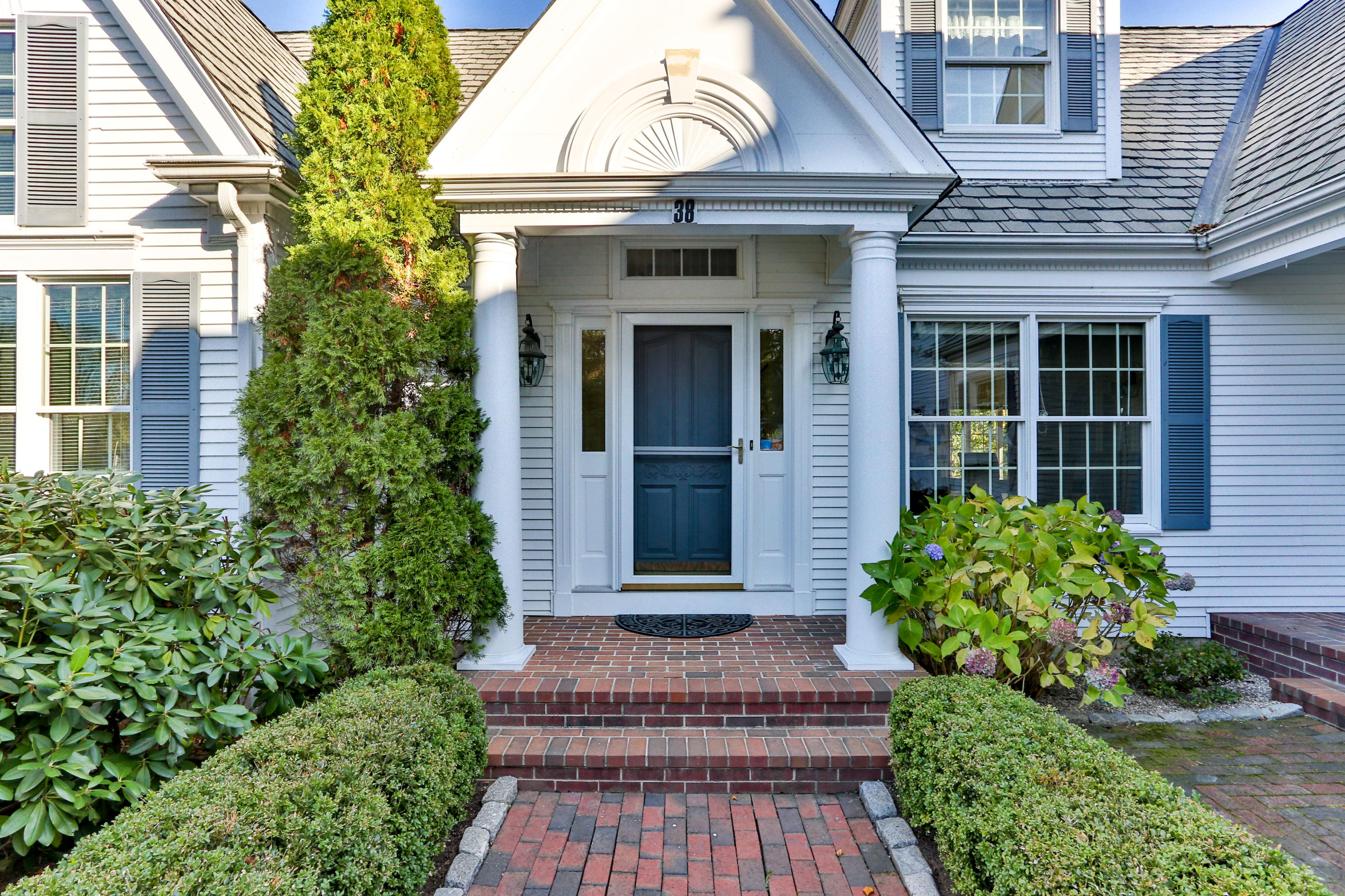 38 Parker Road Osterville, MA 02655 - Photo 3 of 58 a view of a brick house with plants and many windows
