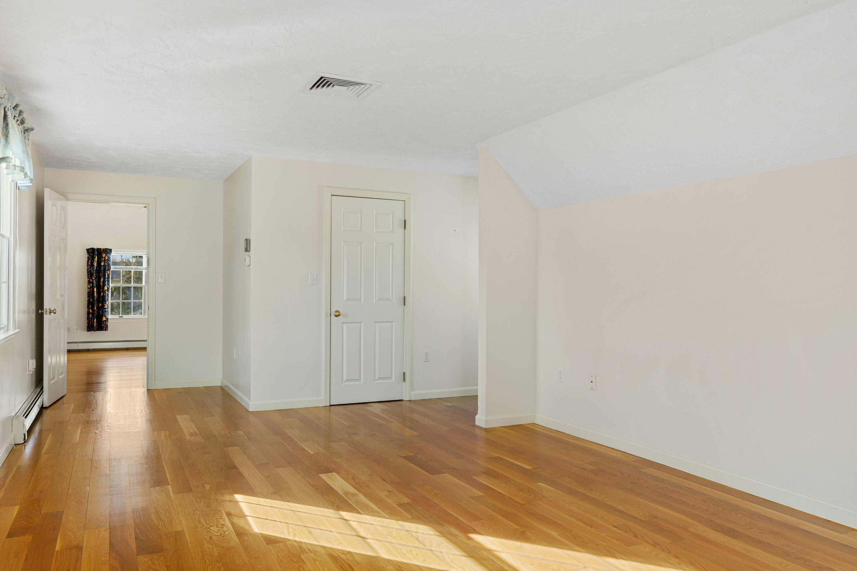 38 Parker Road Osterville, MA 02655 - Photo 34 of 58 a view of empty room with wooden floor and kitchen