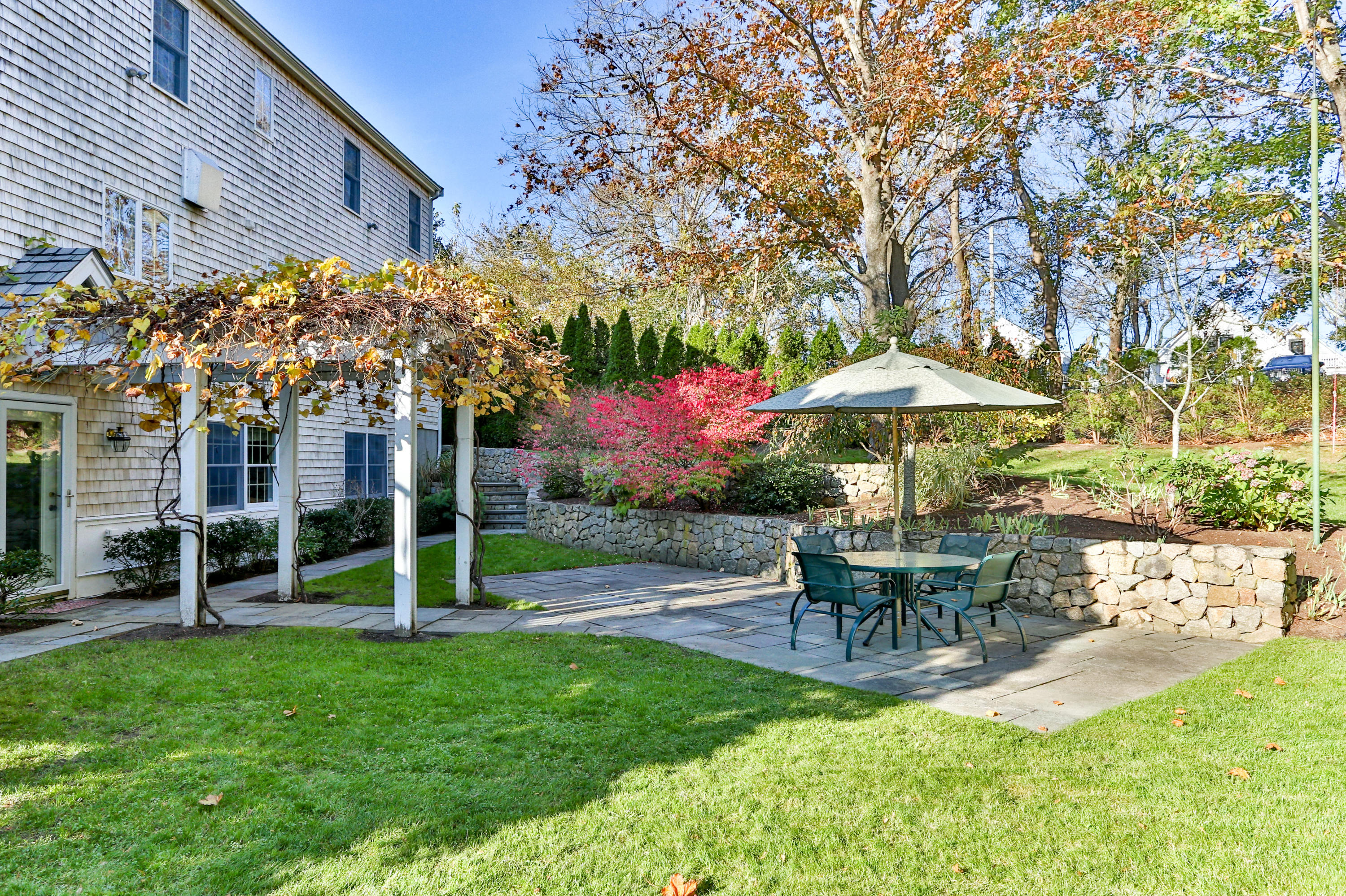 38 Parker Road Osterville, MA 02655 - Photo 52 of 58 a view of a table and chairs under an umbrella