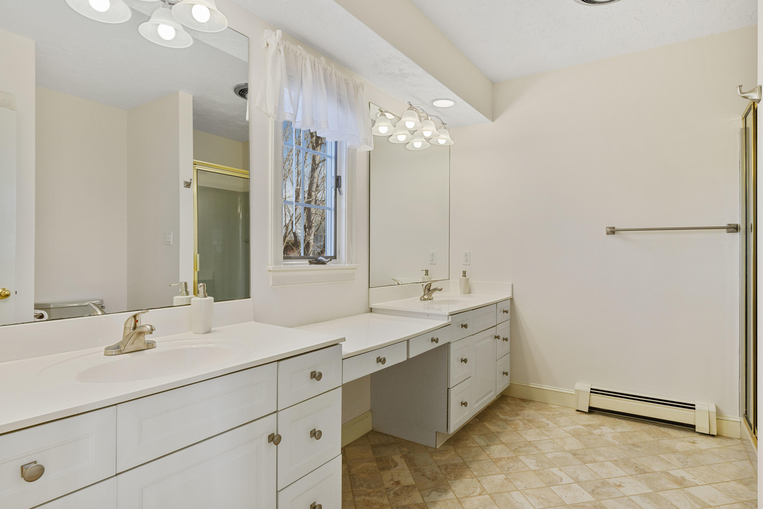 38 Parker Road Osterville, MA 02655 - Photo 9 of 58 a bathroom with a double vanity sink and mirror