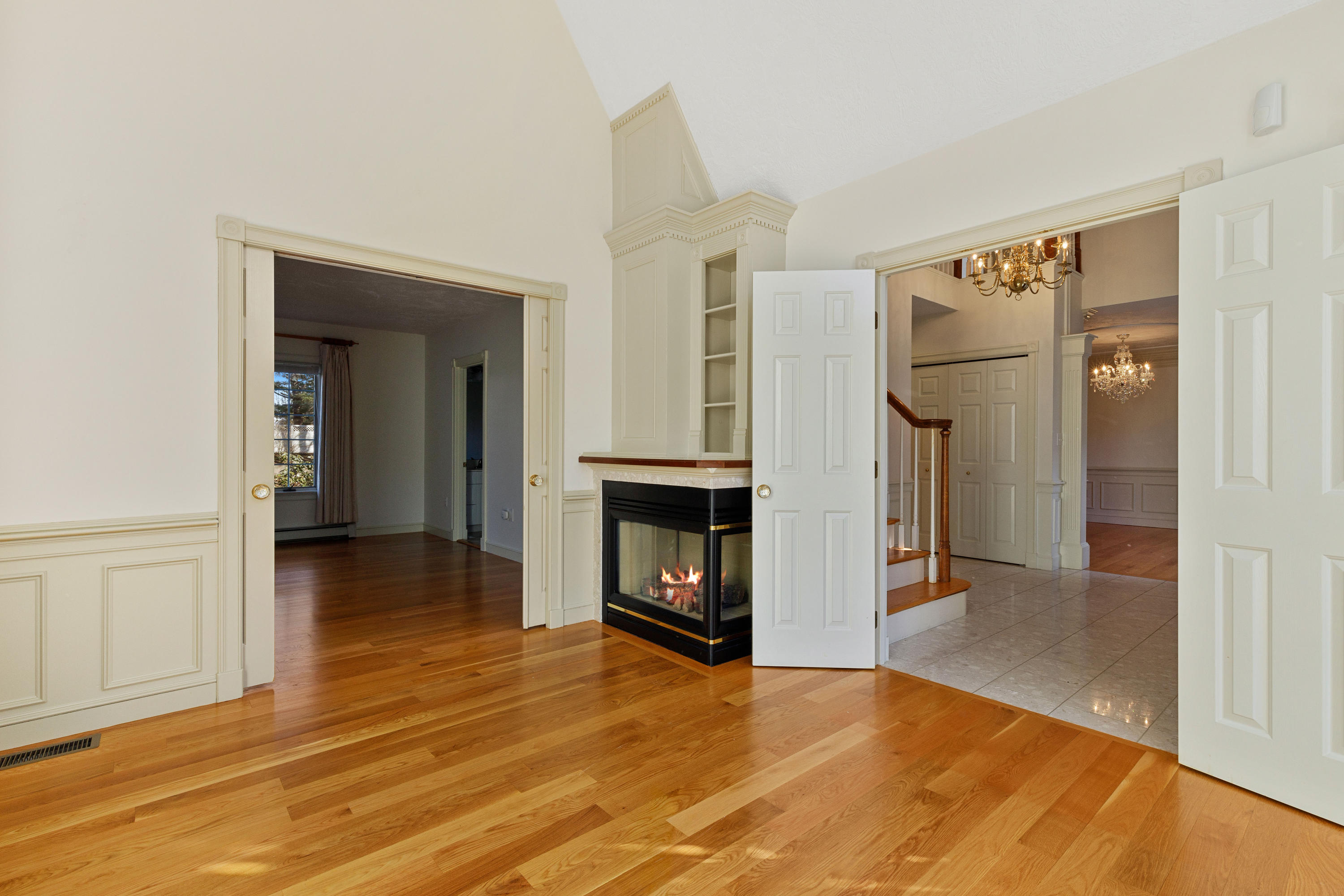 38 Parker Road Osterville, MA 02655 - Photo 10 of 58 a view of an empty room with wooden floor and a fireplace