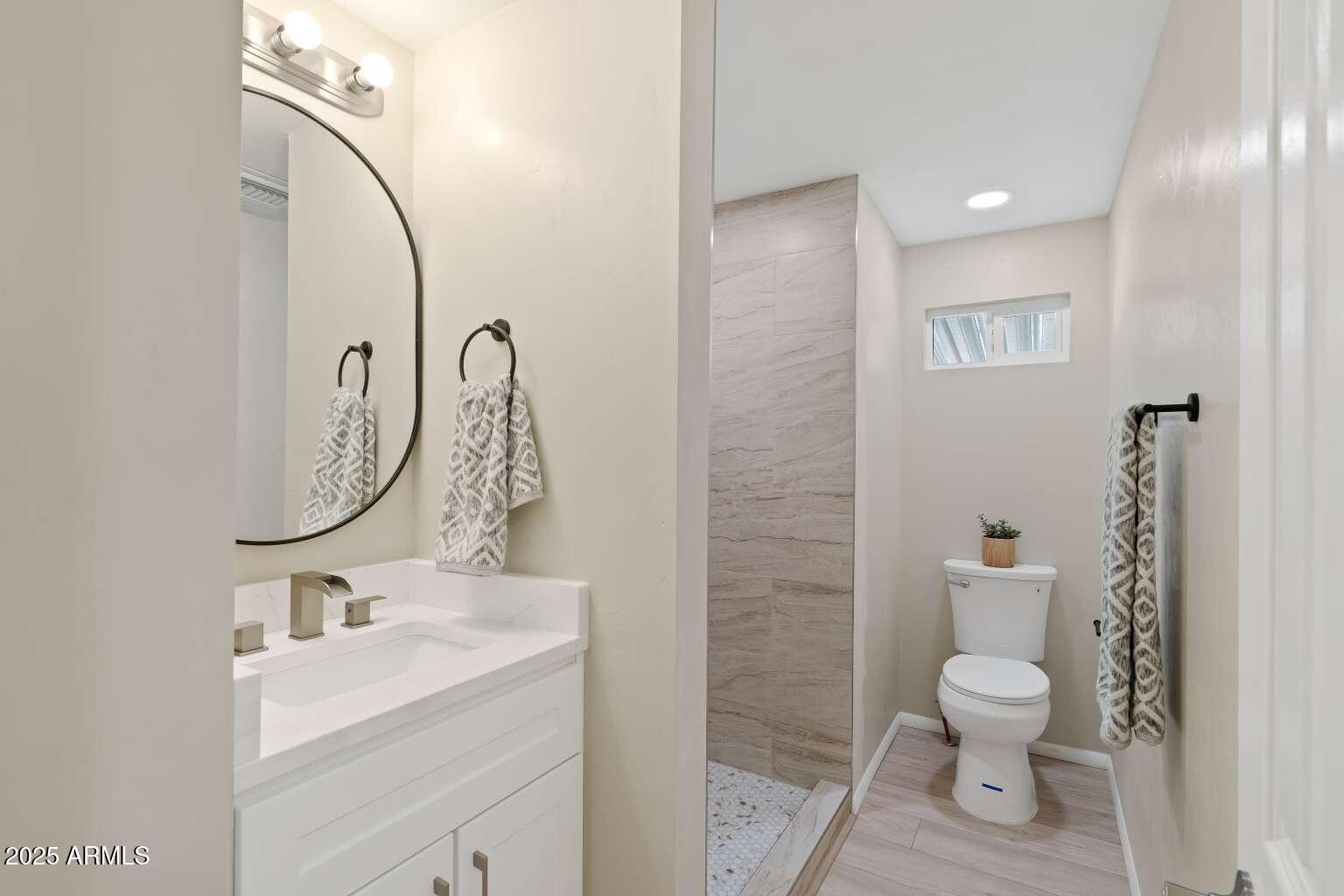 5000 East Grant Road, Unit 203 Tucson, AZ 85712 - Photo 13 of 19 a bathroom with a toilet a sink and mirror