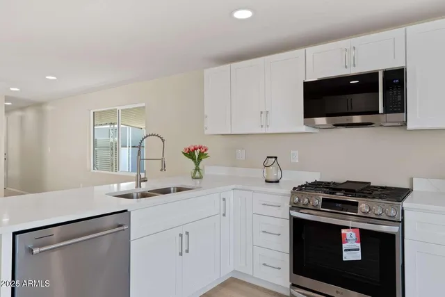 a kitchen with kitchen island a sink and appliances
