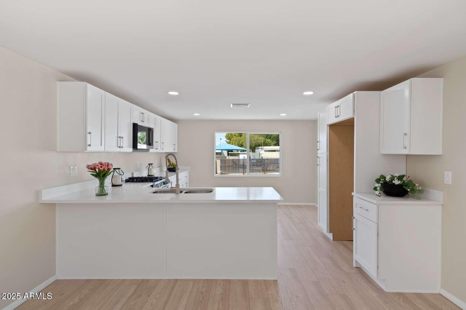 5000 East Grant Road, Unit 203 Tucson, AZ 85712 - Photo 4 of 19 a kitchen with kitchen island a sink and appliances