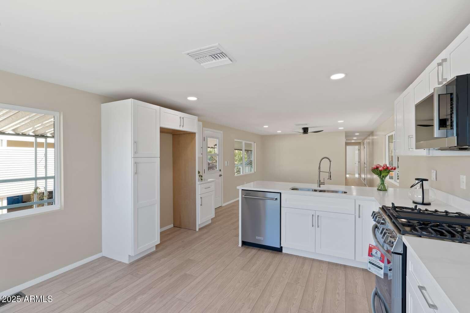 5000 East Grant Road, Unit 203 Tucson, AZ 85712 - Photo 5 of 19 a kitchen with a sink stove and refrigerator