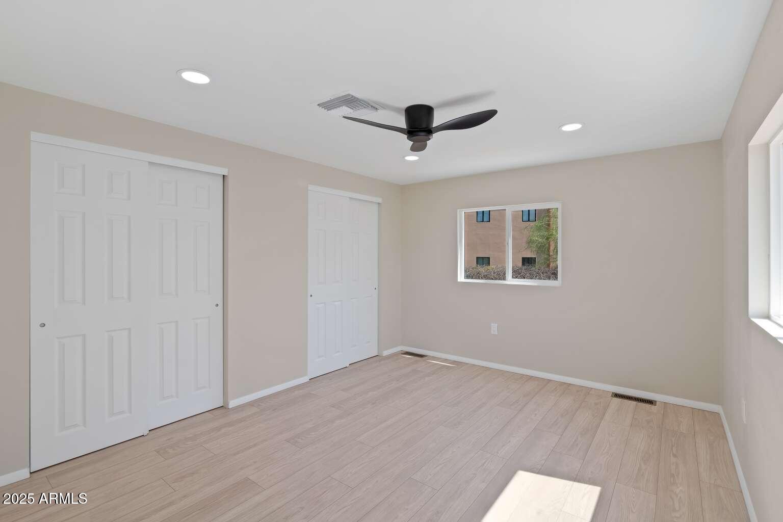 5000 East Grant Road, Unit 203 Tucson, AZ 85712 - Photo 8 of 19 wooden floor in an empty room with a window