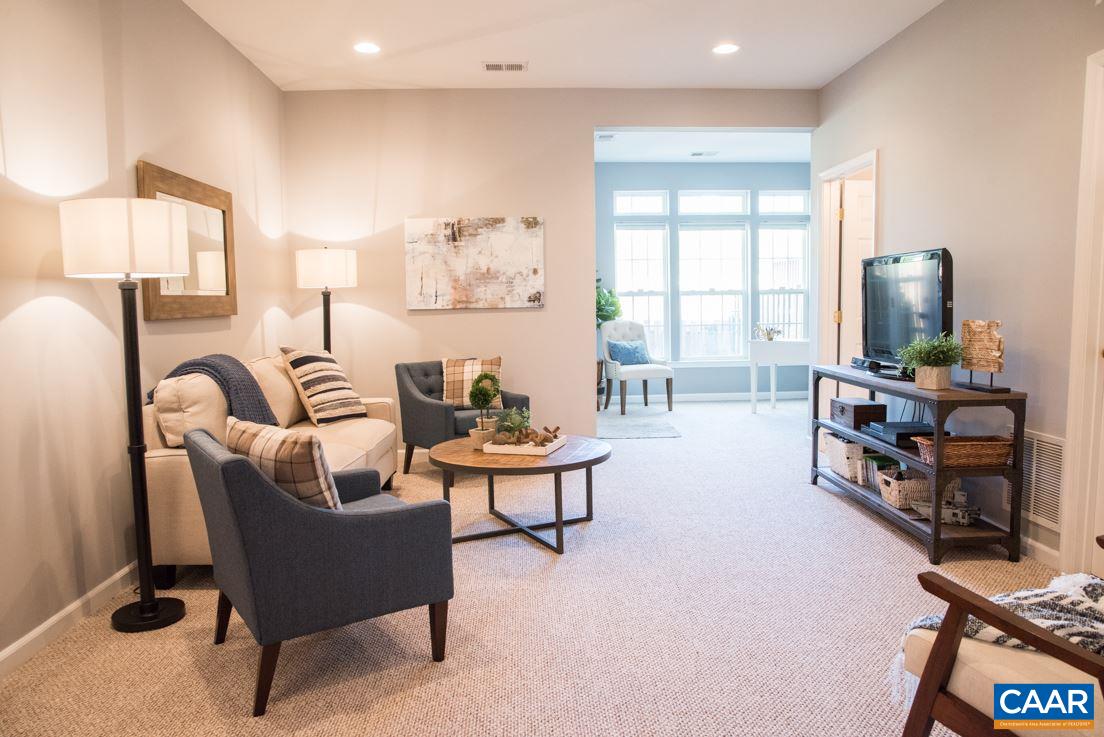 825 Rainier Road Charlottesville, VA 22903 - Photo 5 of 25 a living room with furniture a flat screen tv and a window