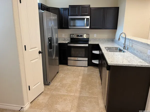 a kitchen with stainless steel appliances a refrigerator and a sink