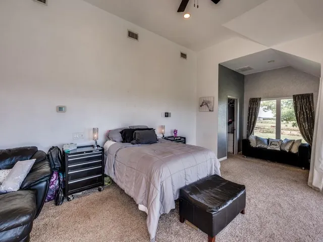 a bedroom with a bed and a couch