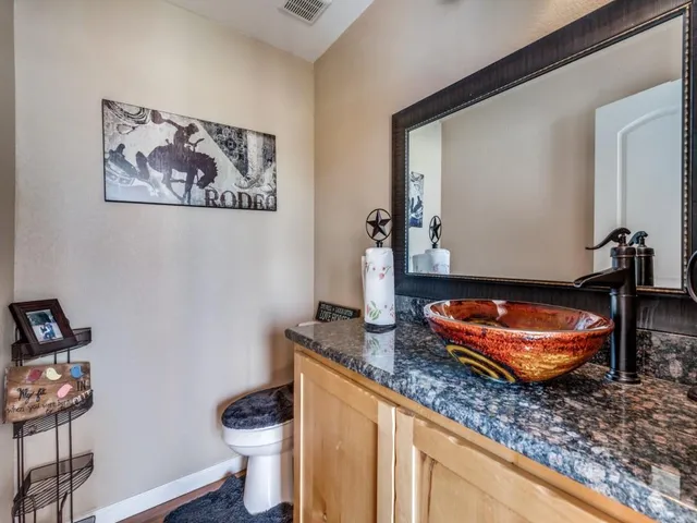 a spacious bedroom with a bed and dresser