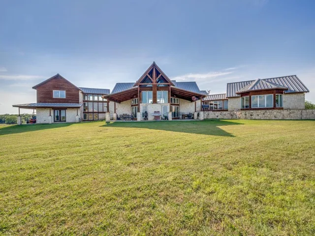 a front view of a house with swimming pool having outdoor seating