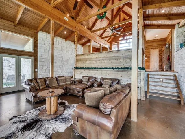 a living room with furniture and a floor to ceiling window