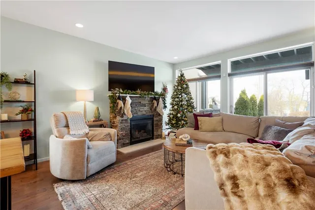 a living room with furniture a flat screen tv and a large window
