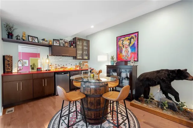 a dining room with furniture and wooden floor