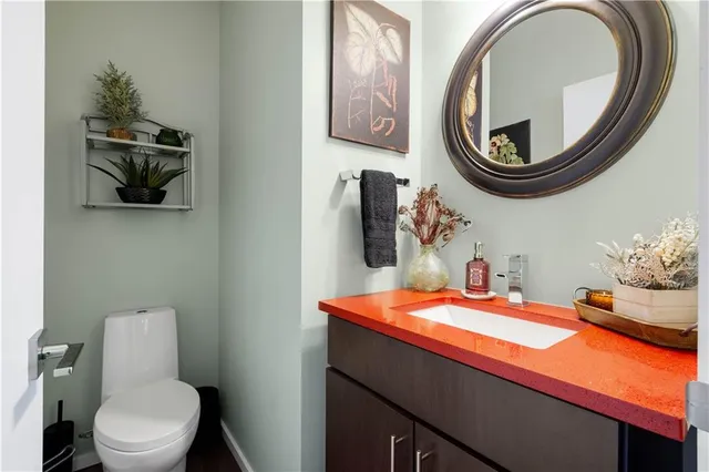 a bathroom with a toilet a sink and a mirror