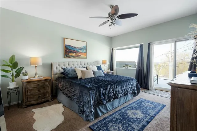 a spacious bedroom with a bed dresser and window