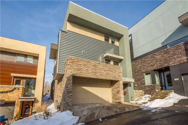 a view of patio with couches table and chairs with wooden floor