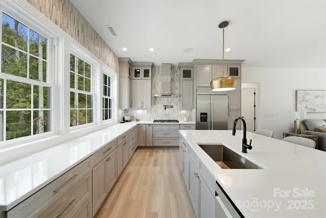 a large kitchen with a sink and cabinets