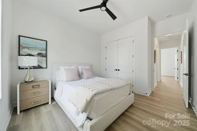 a bedroom with a bed and a night stand