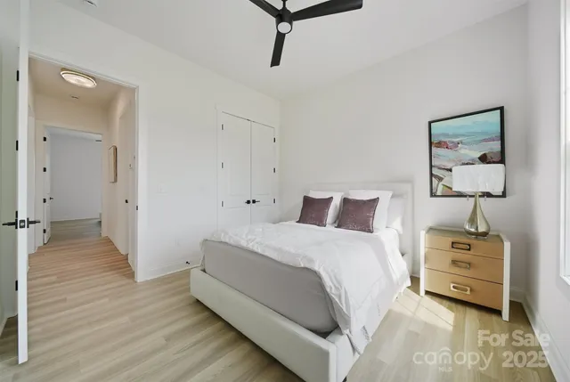 a spacious bedroom with a bed and a table