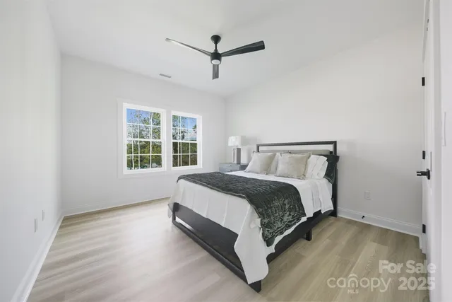 a spacious bedroom with a bed and window