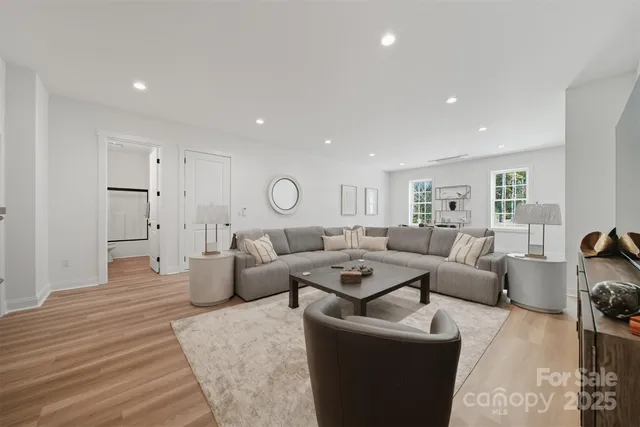 a living room with furniture and wooden floor