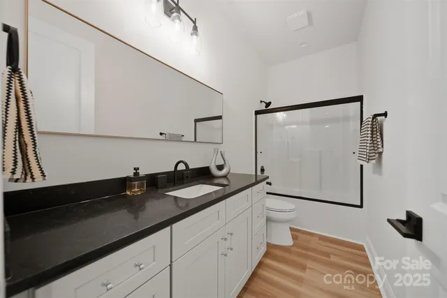 a spacious bathroom with a double vanity sink and mirror