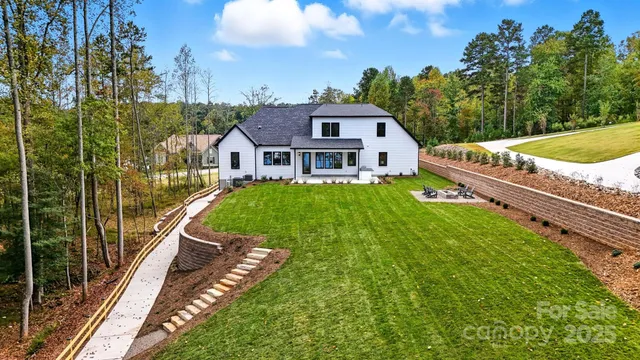 a view of a house with a big yard and potted plants